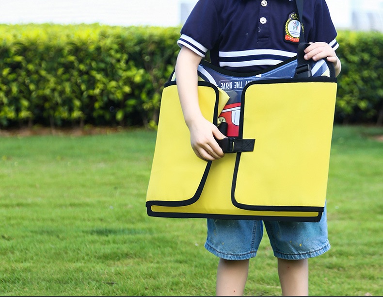 Child carrying the folded yellow travel tray outdoors