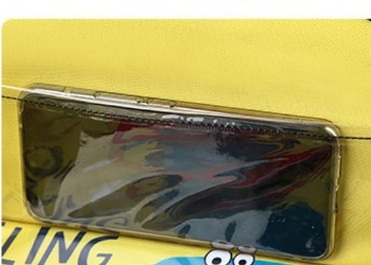 Clear pocket holding a phone inside the kids travel tray