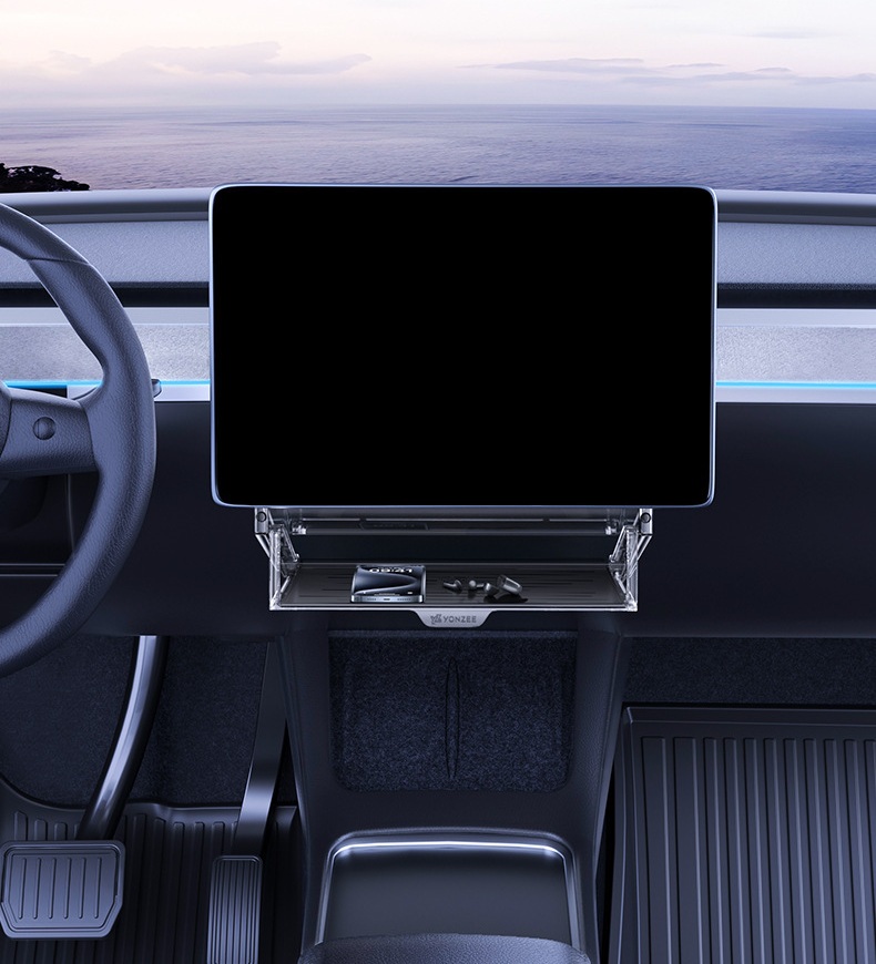 Front view showing the storage organizer positioned behind and below the Tesla center display
