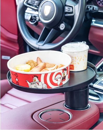 Round car tray holding takeout food in a front console