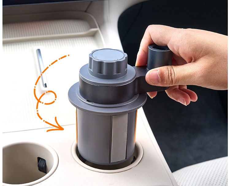 Cup holder mounting base being installed in a vehicle center console