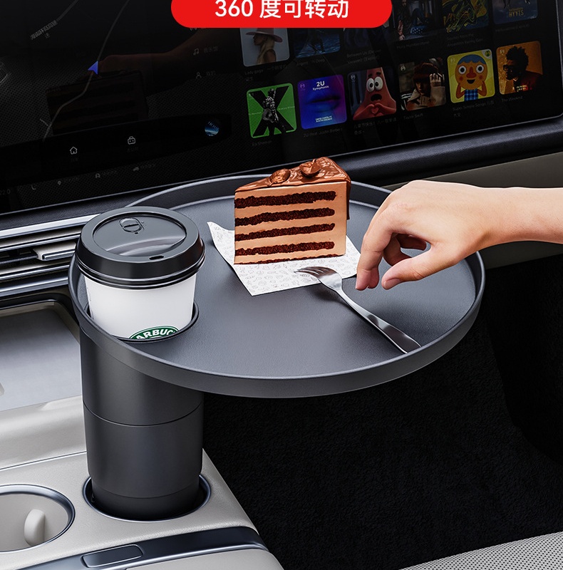Round car tray holding a drink and dessert inside a parked vehicle