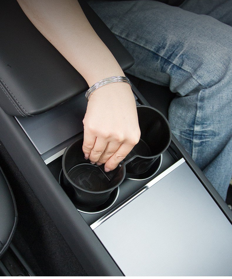 Hand removing or adjusting the silicone cup holder insert in the Tesla center console