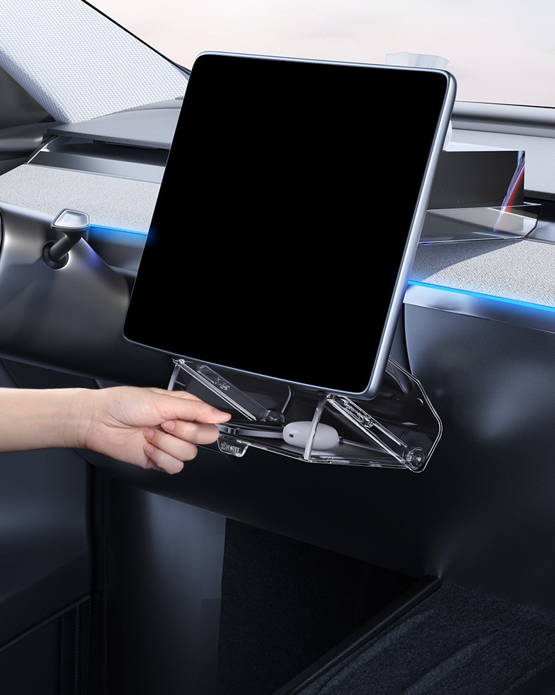 Hand reaching into the storage compartment below the Tesla center screen