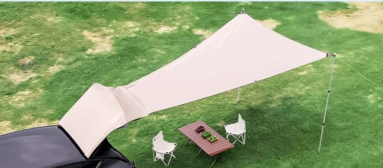 Model Y rear hatch awning fully opened over an outdoor seating area