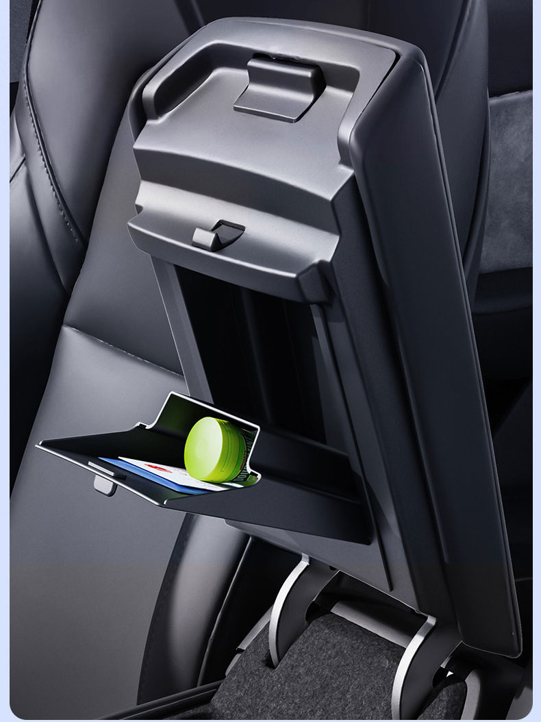 Tesla center console hidden storage box open with small items inside