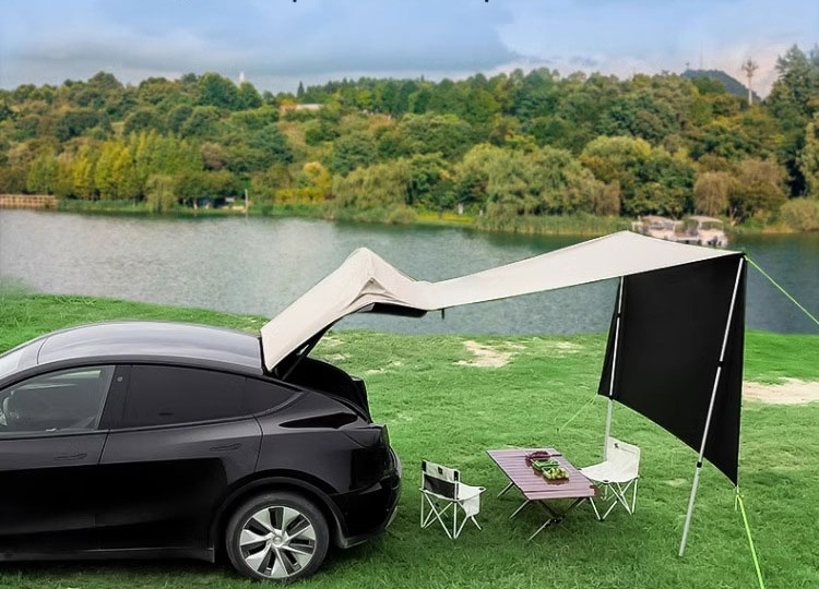Tesla Model Y rear hatch awning set up beside a lake