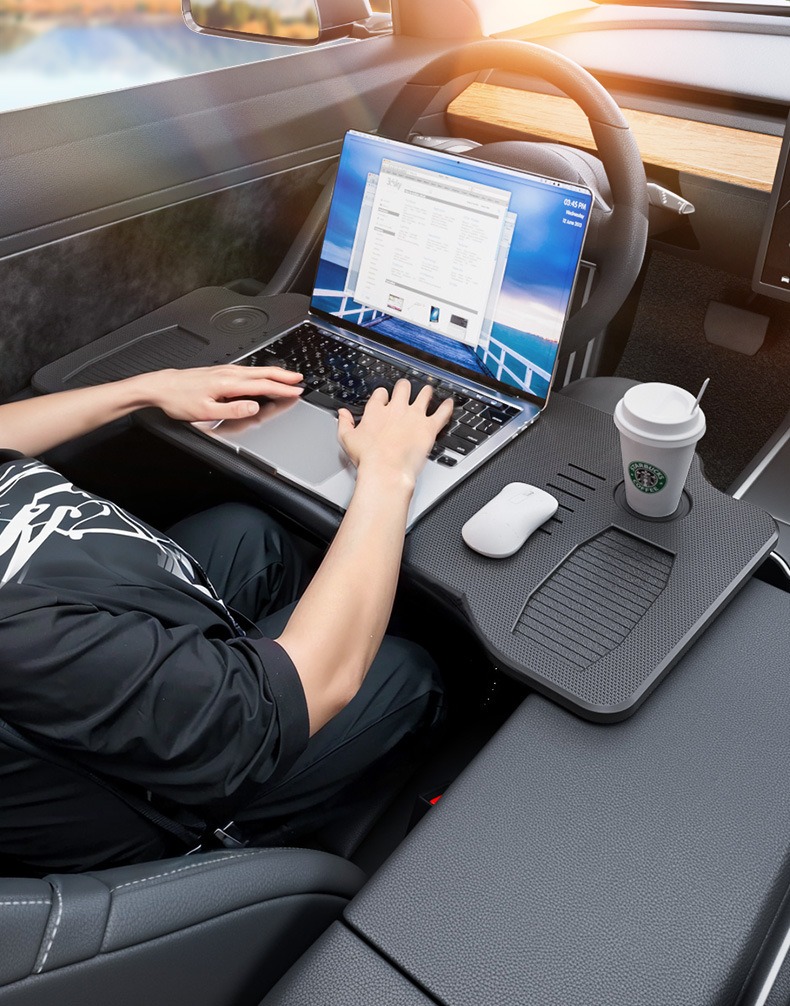 Foldable car desk tray used with a laptop inside a parked car