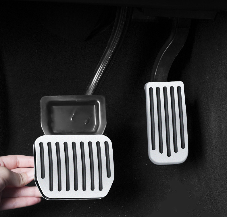 Brake pedal cover being pressed onto the pedal by hand