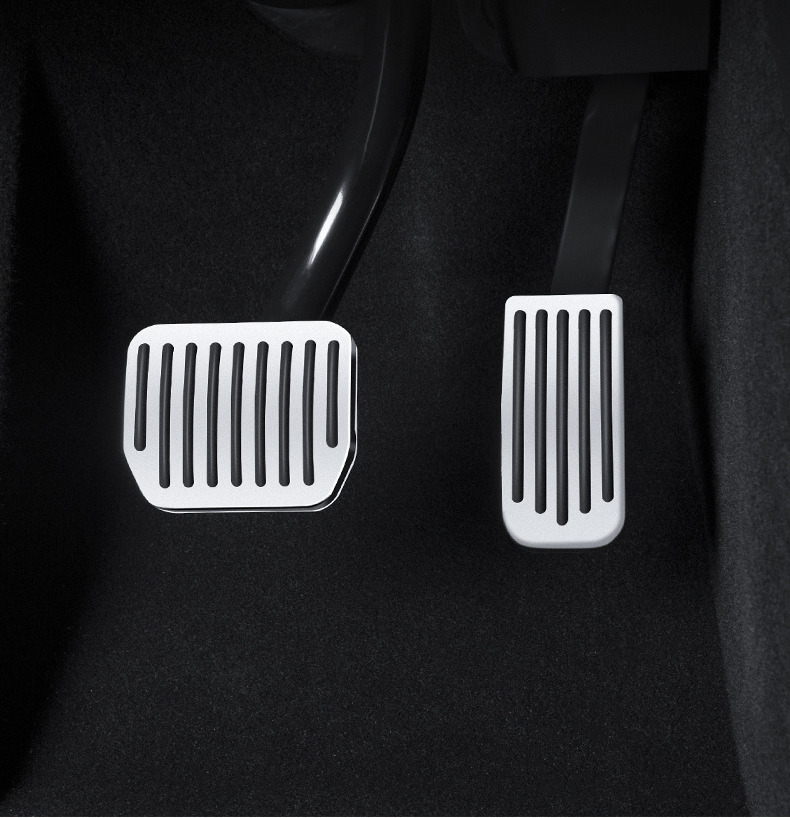 Silver and black brake and accelerator pedal covers installed