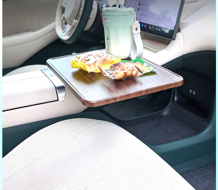 Car tray table holding snacks inside a vehicle