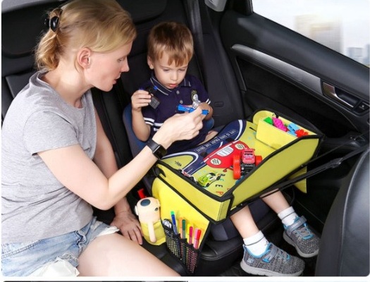 Parent and child using the kids travel tray in a vehicle