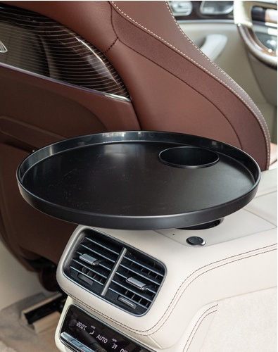 Round car tray installed at a rear center console