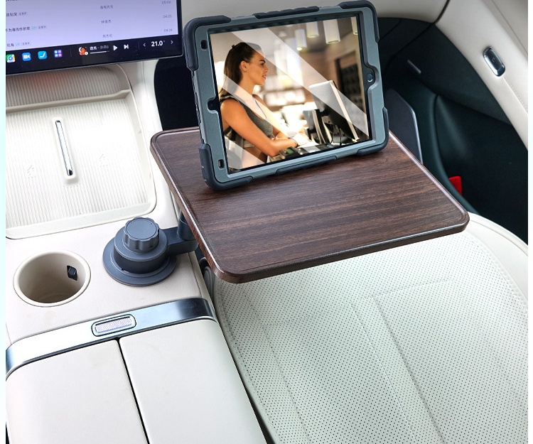Tablet resting on a car cup holder tray table