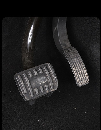 Original Tesla pedals before adding pedal covers