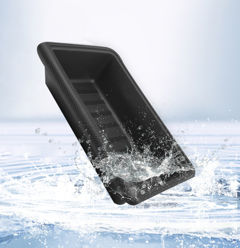 Black TPE storage tray being rinsed with water