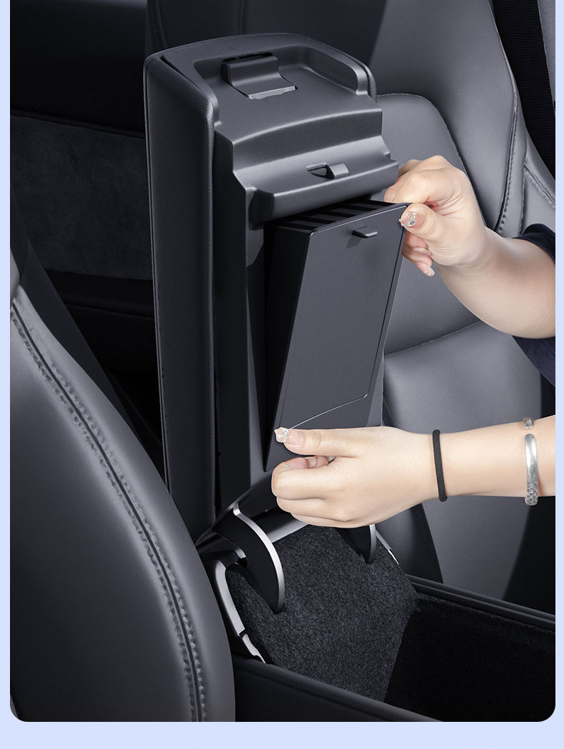 Hidden organizer being pressed into the center armrest area by hand